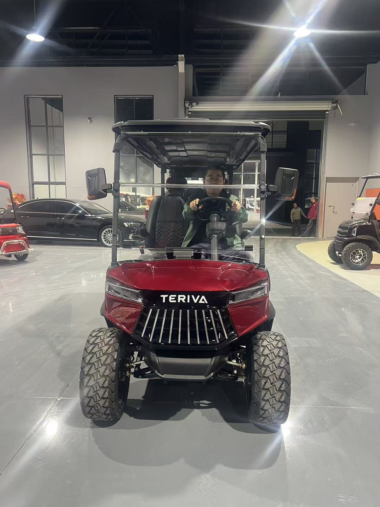 Front view of red TERIVA cart showing windshield, canopy and grille